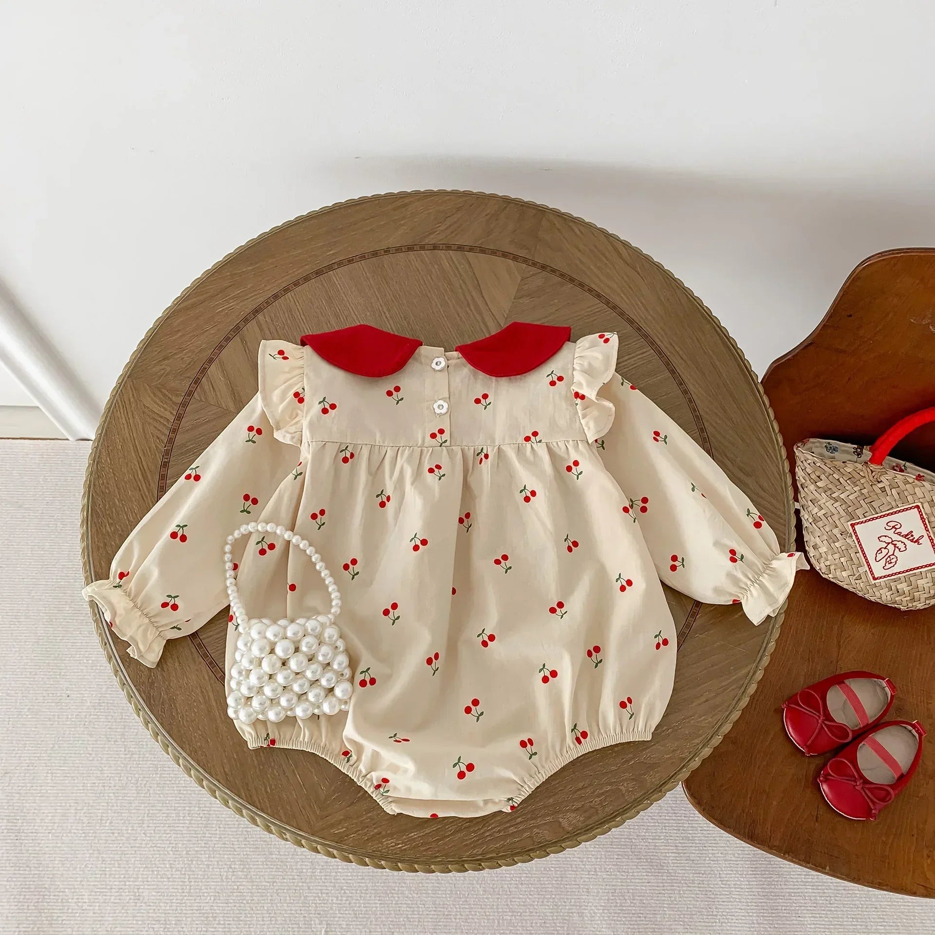 Long-sleeve cotton jumpsuit with cherry print