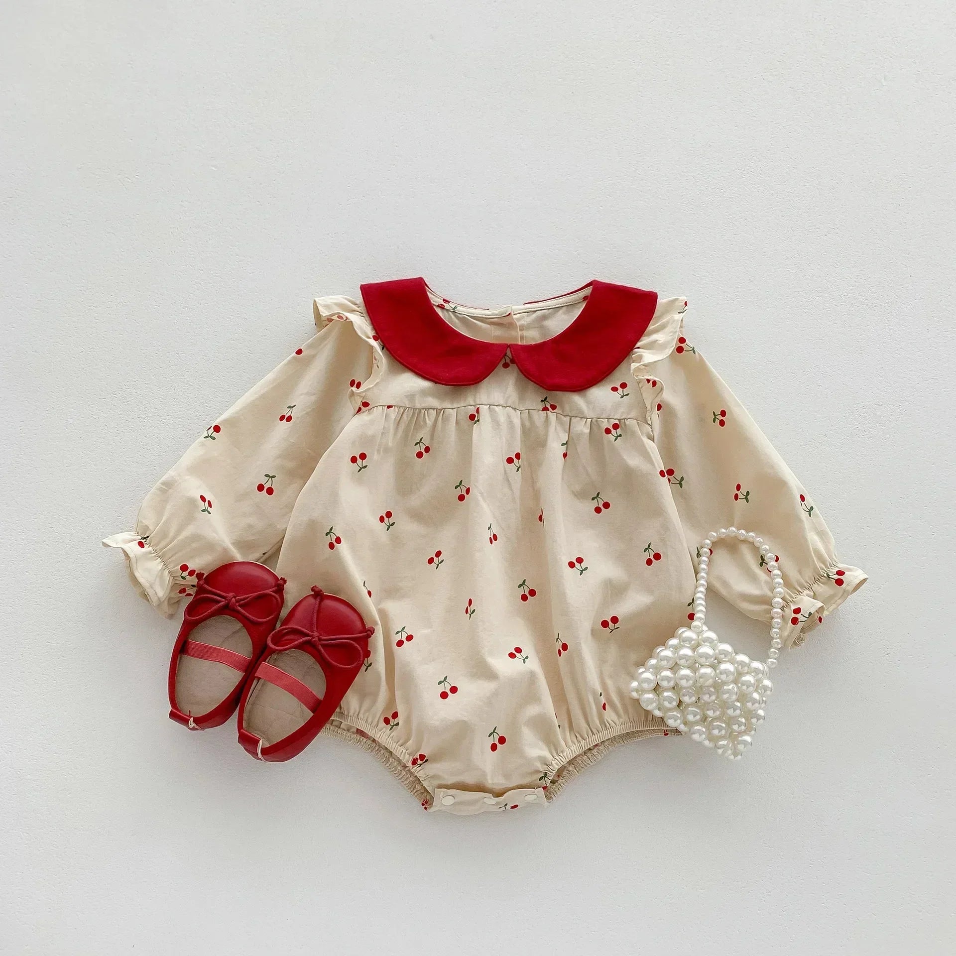 Long-sleeve cotton jumpsuit with cherry print